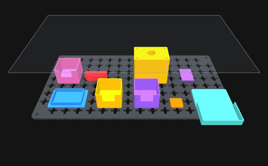 A camera case laid out on the MODÜLES grid, loaded with coloured trays, bins and a cradle.